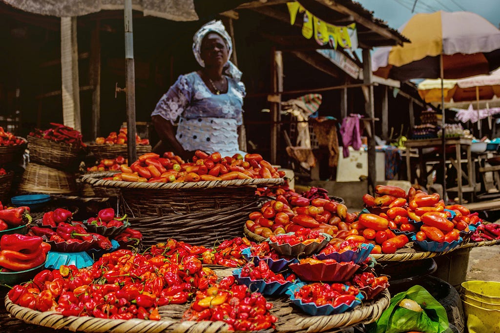 a tomato and pepper seller in a typical Nigerian market
