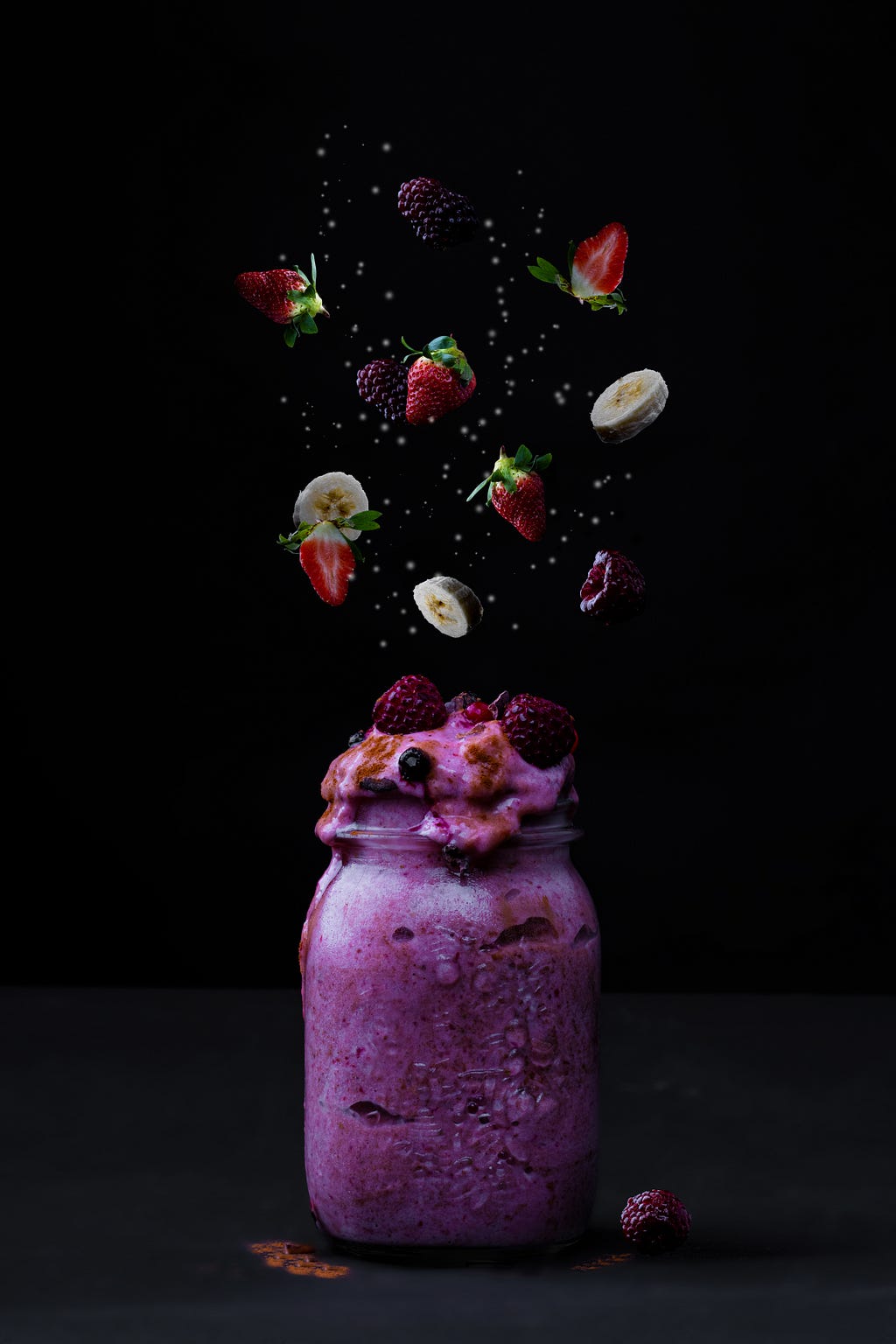 A purple-colored smoothie with bits of fruits