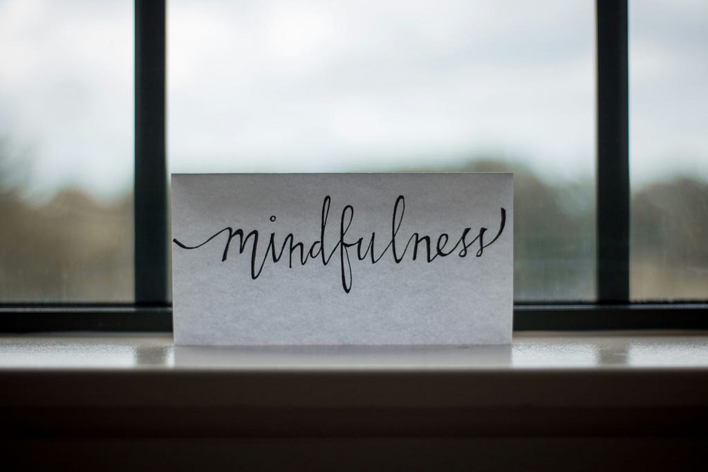 A text mindfulness in written in a white paper.