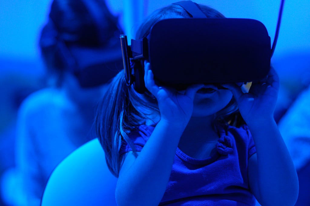 A young child wearing a virtual reality headset.