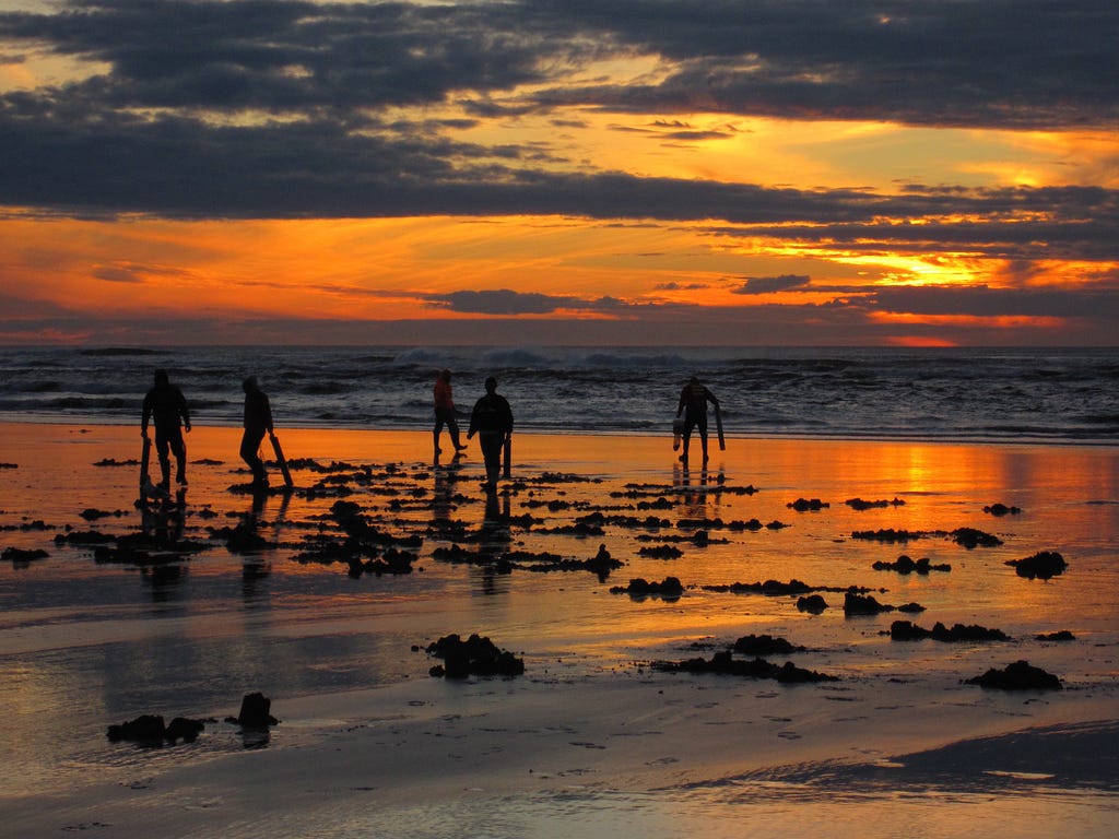 People on the beach at sunset