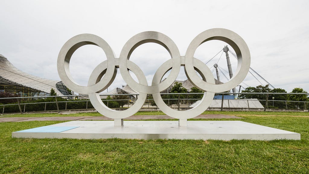 A large, metal ornamental depiction of the Olympic Rings but with no colours