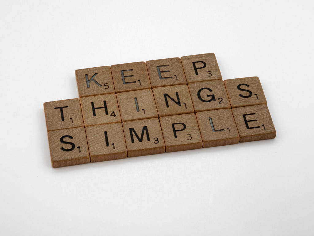 A picture of scrabble board words arranged to say, “keep things simple,” used to summarize the article’s main point of minimalism.