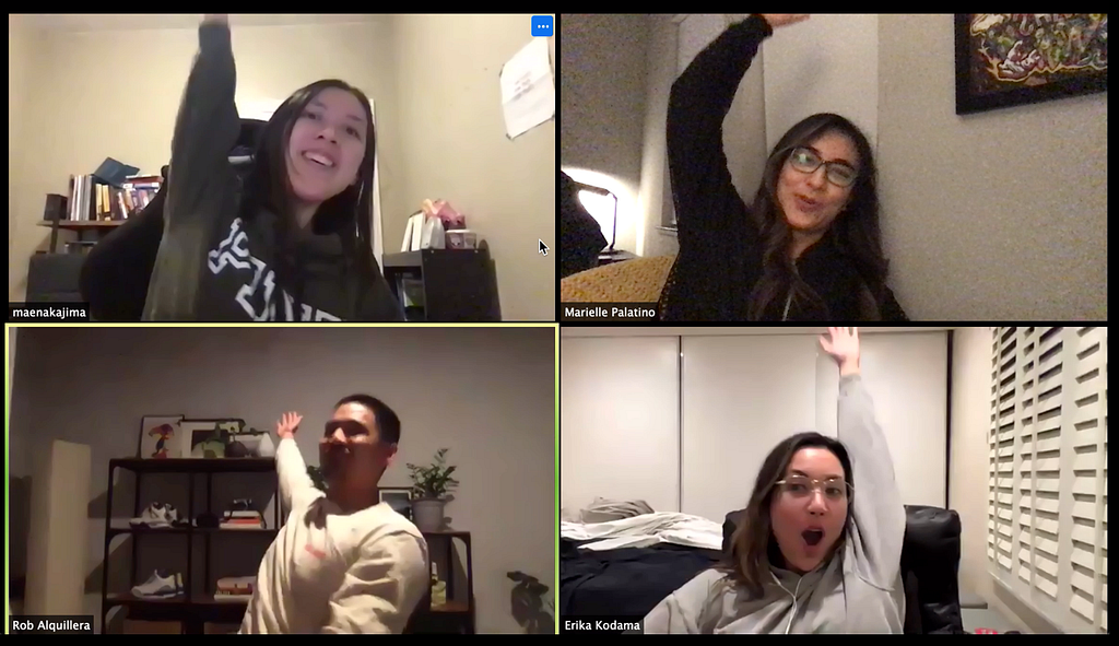 A screenshot of a zoom meeting with four people cheering