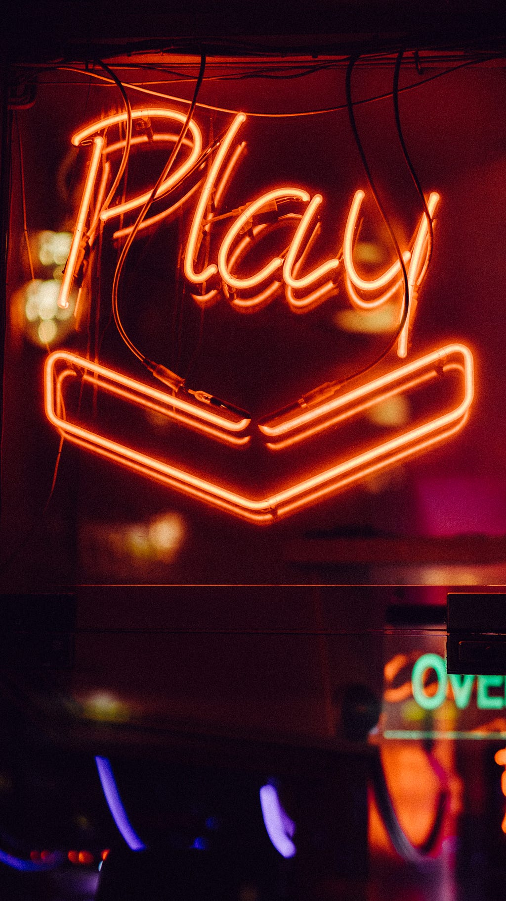 Neon sign that says “play”