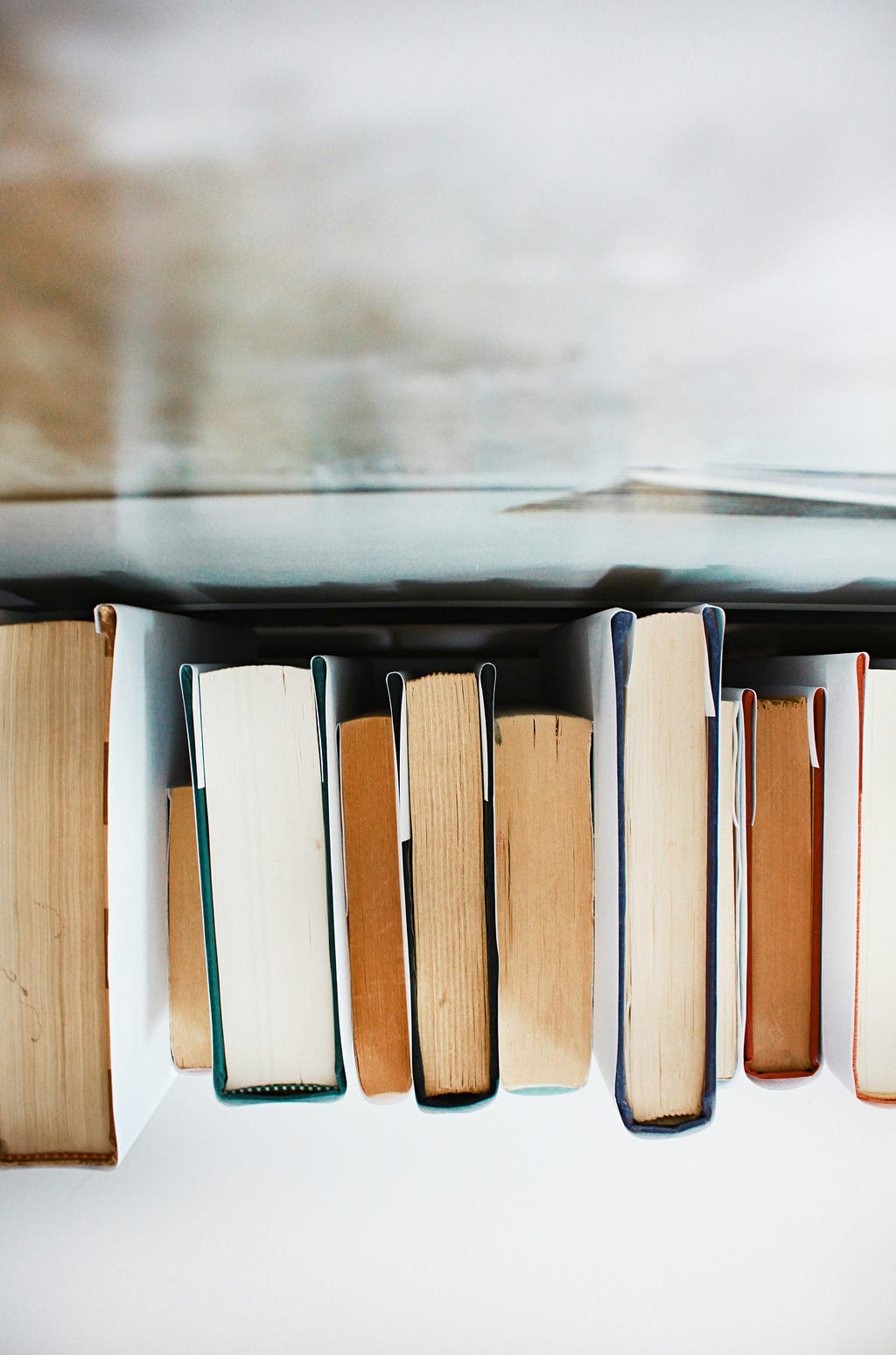 Horizontal row of books upside down.