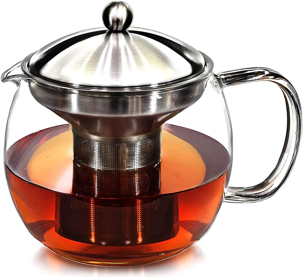 A glass teapot with a built-in strainer basket. Inside the teapot is some still-steeping black tea.