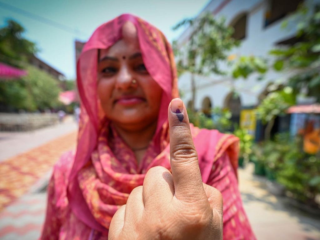 A voter shows her inked finger after casting her vote at a polling station in New Delhi, India, May 25, 2024. Photo by Sanchit Khanna/ Hindustan Times/Sipa USA via Reuters