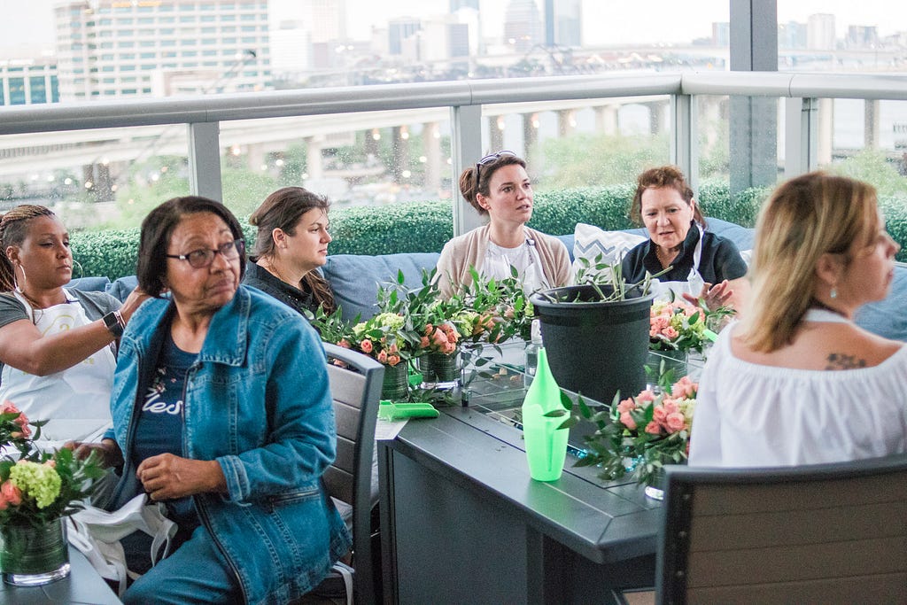 women learning about making flower arrangements during Alice's Table workshop in Jacksonville, Florida