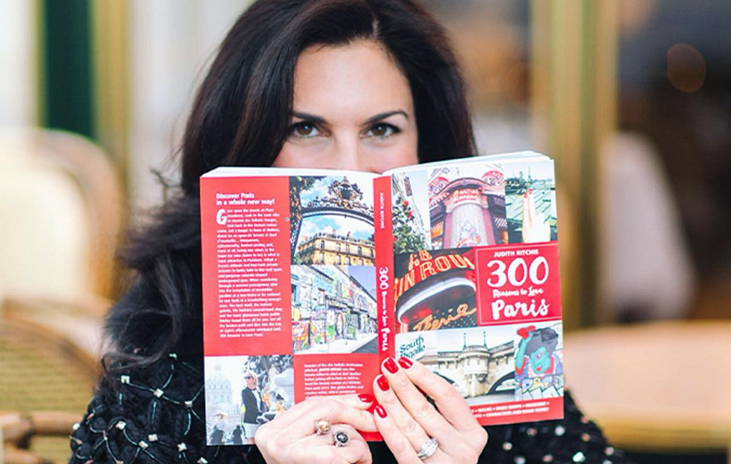 Elisabeth reading a Paris travel book