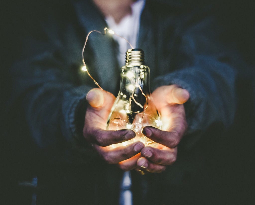 a man holding a light bulb