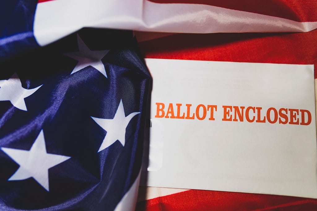 A lable printed with “Ballot Enclosed” on American flag.