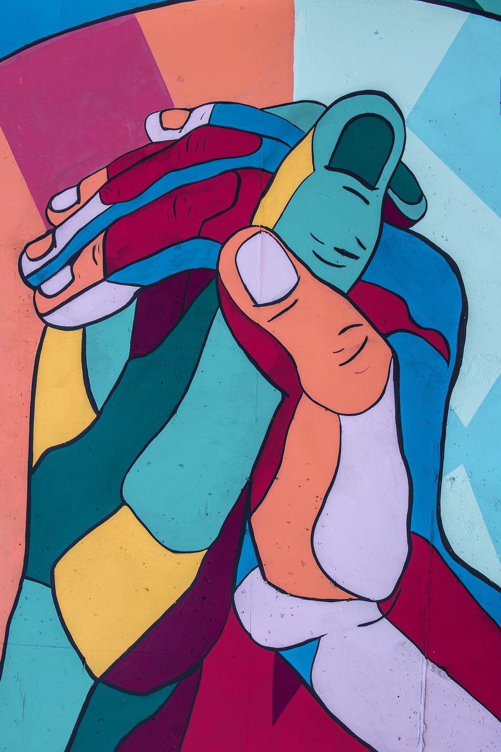 Colorful painting of clasped hands