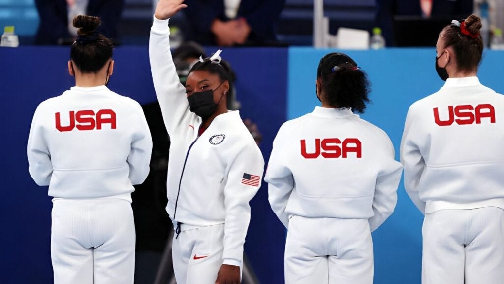 In Tokyo, Japan on July 27, 2021, Simone Biles of Team USA waves to the crowd during presentations before the Women's Team Final on day four of the Tokyo 2020 Olympic Games. The event took place at the Ariake Gymnastics Center. (Image: Getty Images)