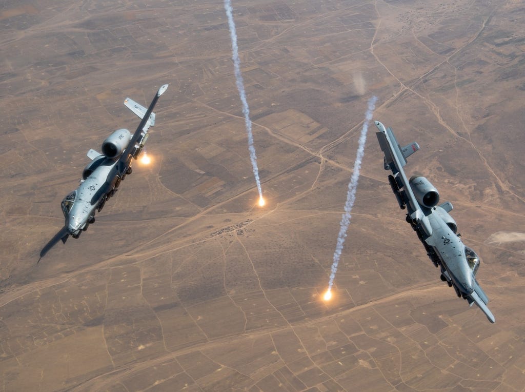 Two USAF A-10 Thunderbolt IIs release countermeasure flares. Photo by Staff Sgt. Justin Parsons/U.S. Air Force