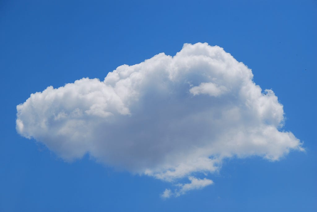 a fluffy white cloud in a blue sky