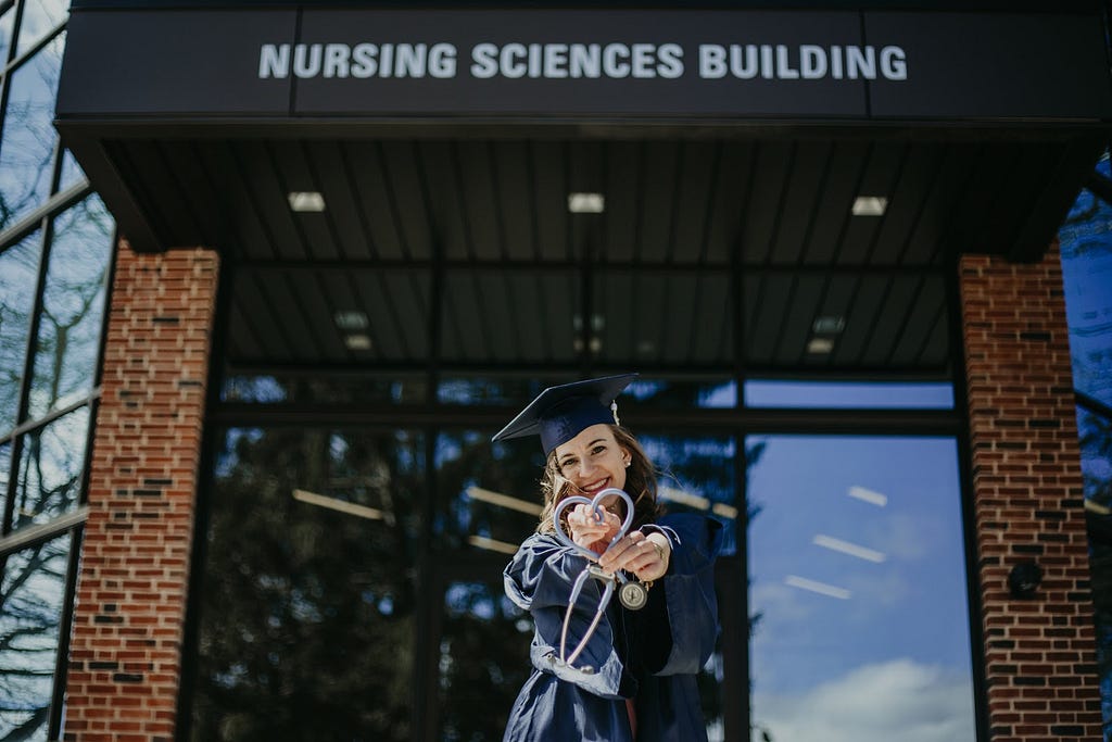 Alex Lilly poses in front of the nursing sciences building at Penn State.