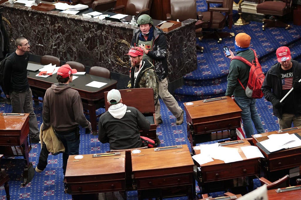 Protesters, including Larry Brock in back, enter the Senate Chamber on January 06, 2021 in Washington, DC.