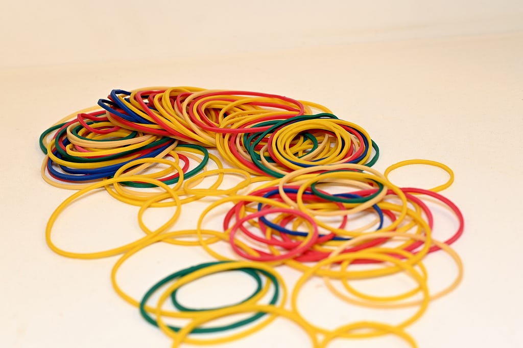 A pile of elastic bands on a white background