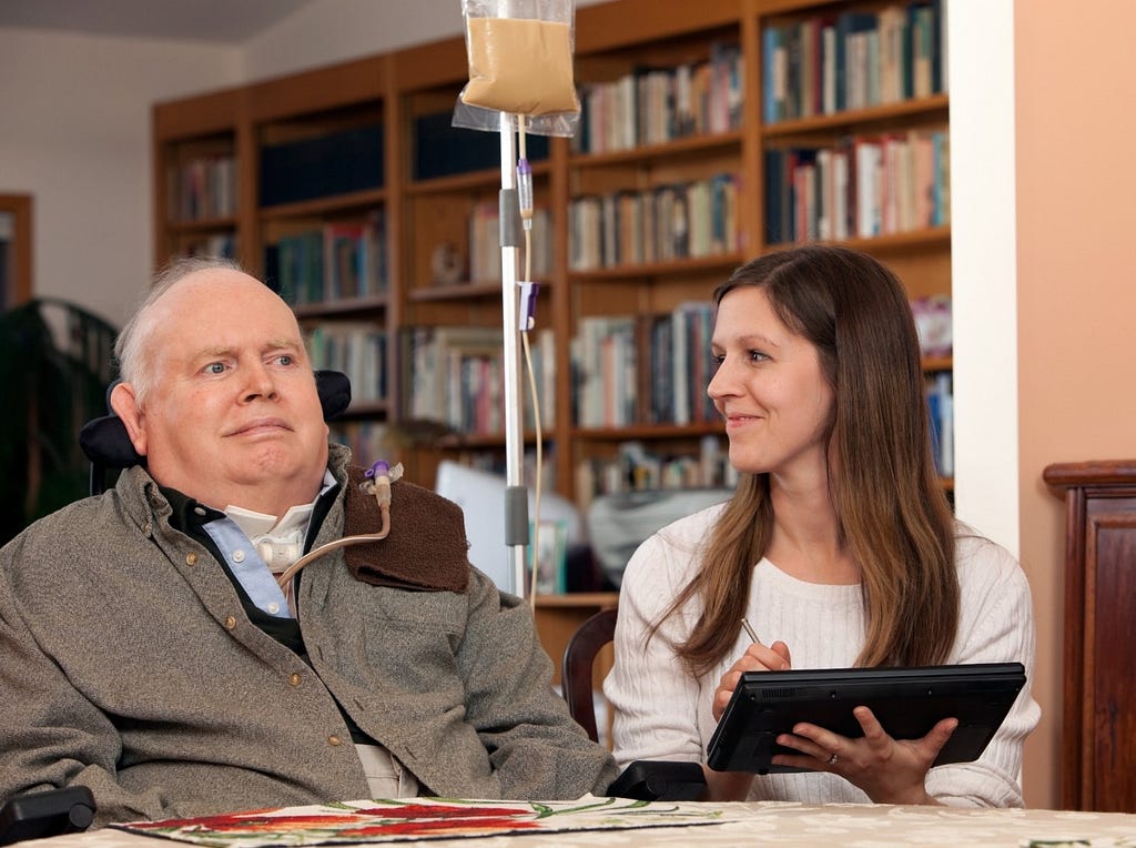 A man with MS and his caregiver. Photo by BanksPhotos/Getty Images