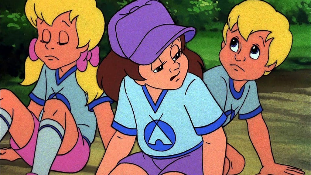 Three young white people sat on the ground, exhausted and sad. Two girls, one boy. One girl and the boy are blonde — they are siblings — the other is brown-haired.