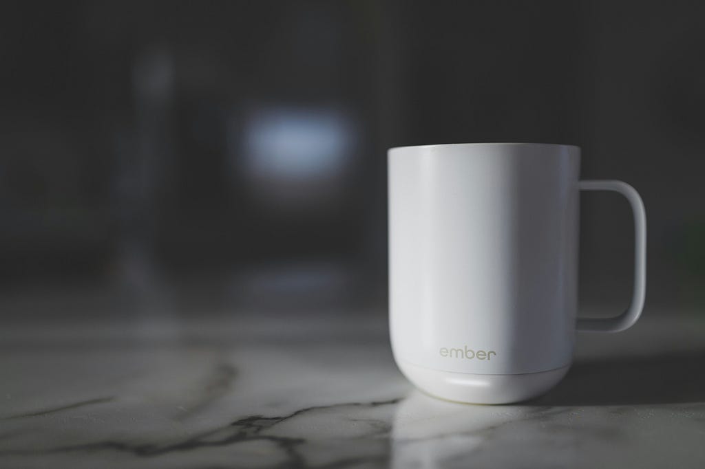 Image of a white Ember mug on a marble countertop.