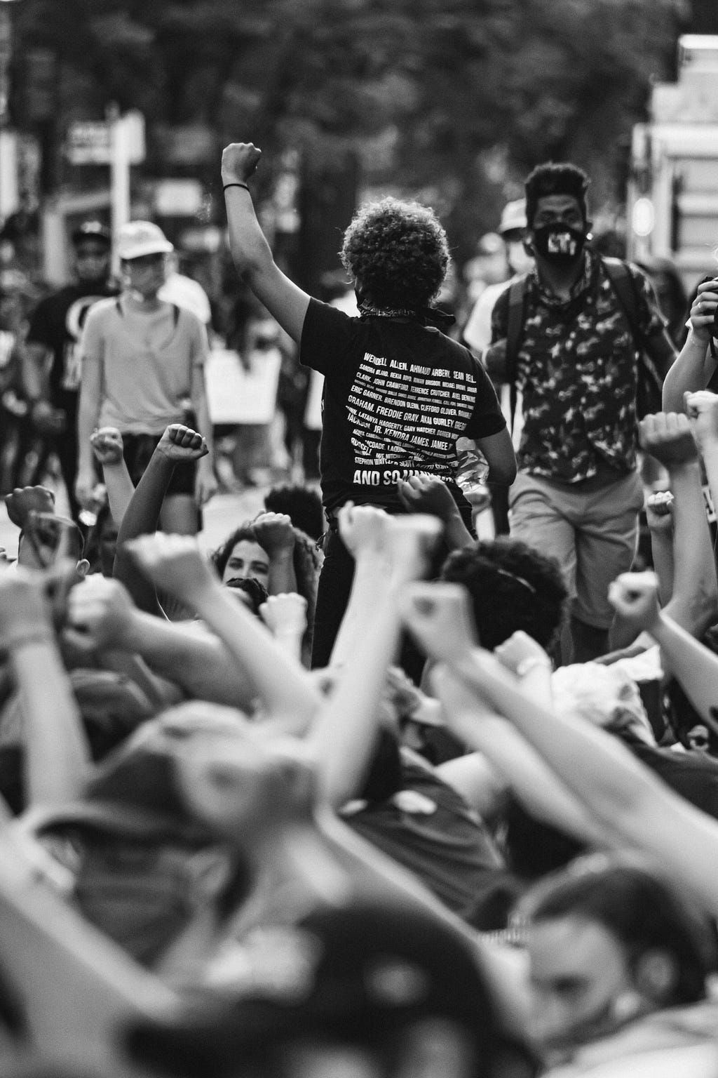 outdoor crowd of people raising fists