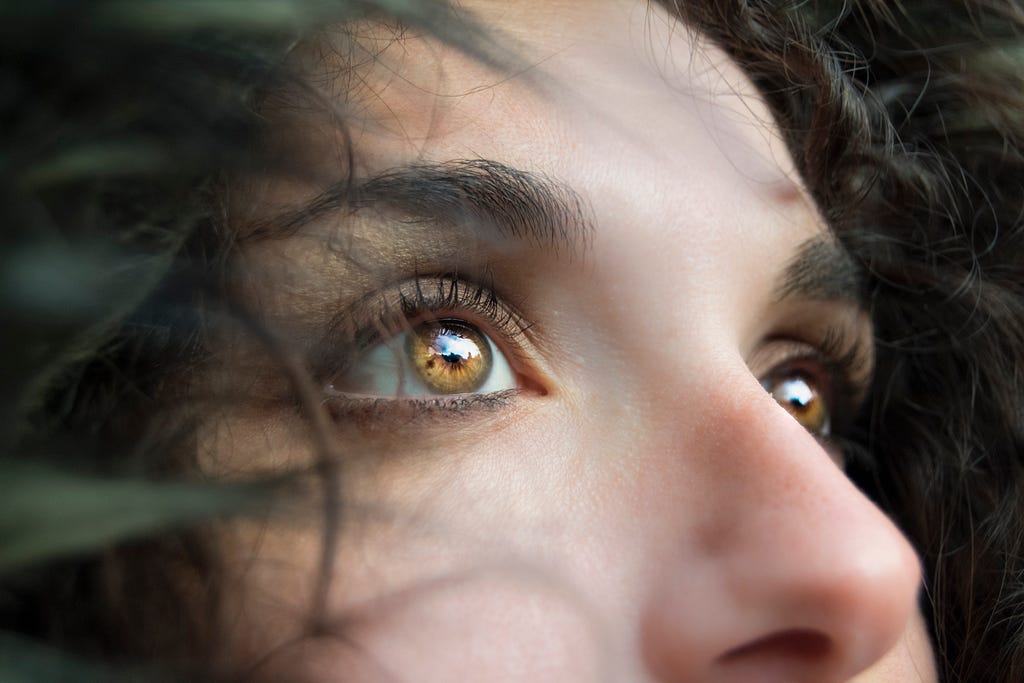 A woman gazing at something in fear.