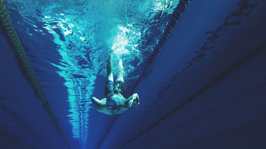 A swimmer underwater at the bottom of a dive