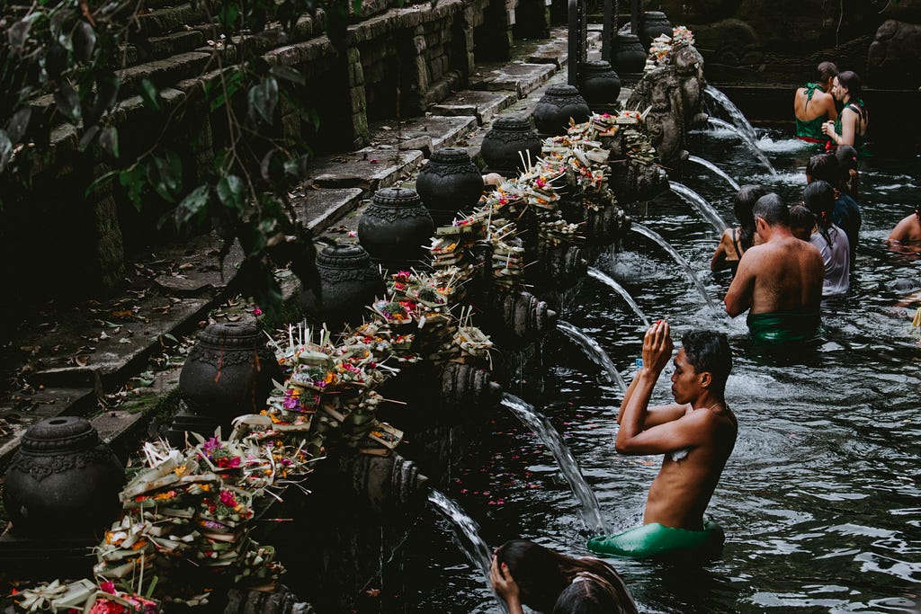 People washing themselves in holy spring water