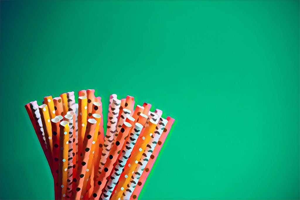Paper straws with a green background