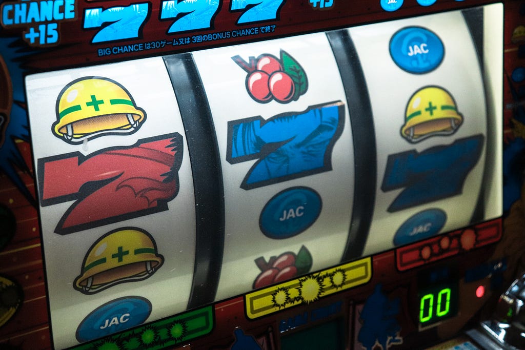 A slots machine showing three sevens.