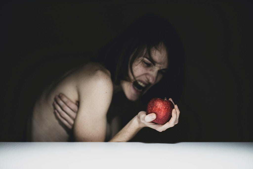 An Eve in anguish, holding an apple. Quite scary looking.