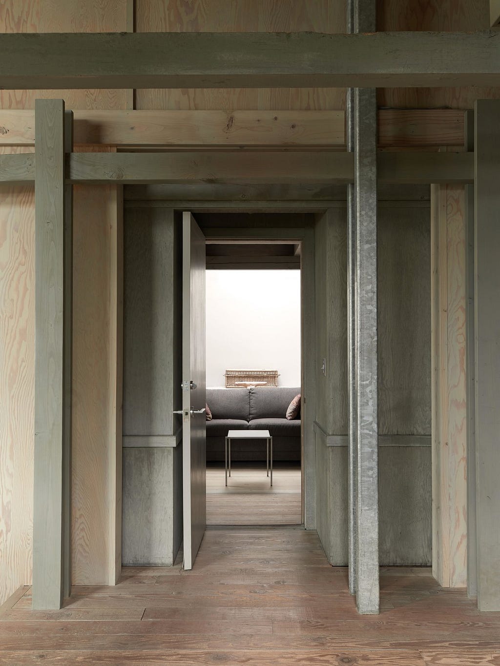 Hallway and Medium Hardwood Floor Simple, readily available materials were used throughout: wood-framed walls are sheathed in plywood or recycled boards, and doubled pairs of steel columns support beams that in turn support exposed roof structures.&nbsp;