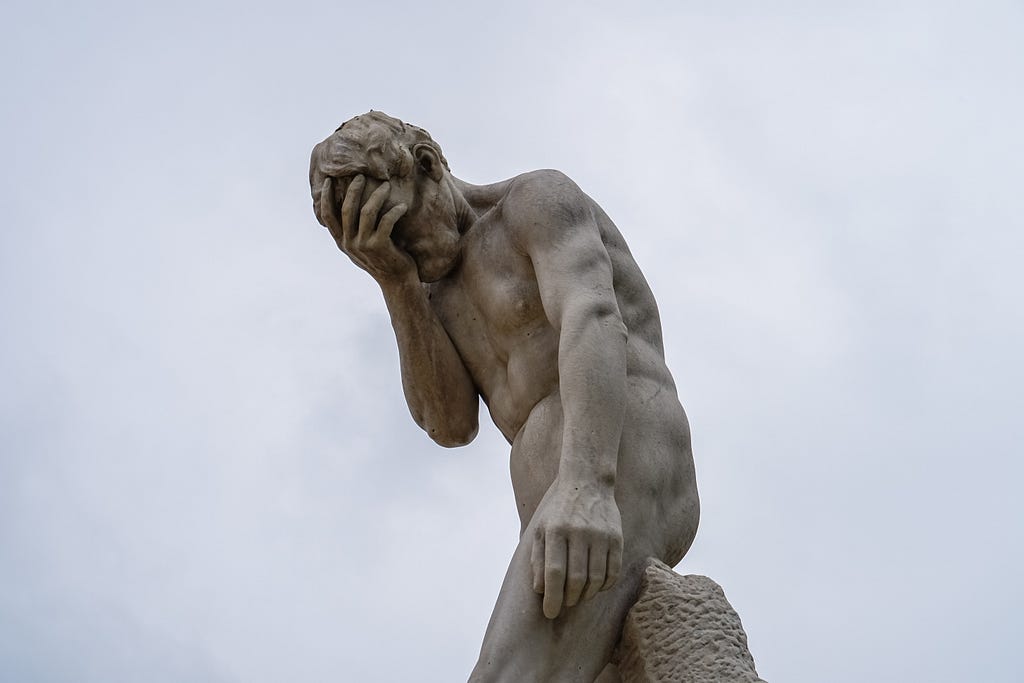 A facepalming statue