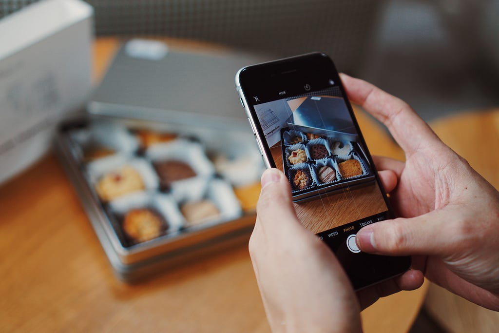 A person taking a picture of their food with their phone