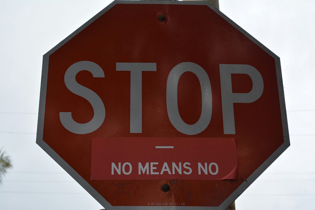 Stop sign reading ‘Stop, no means no’.