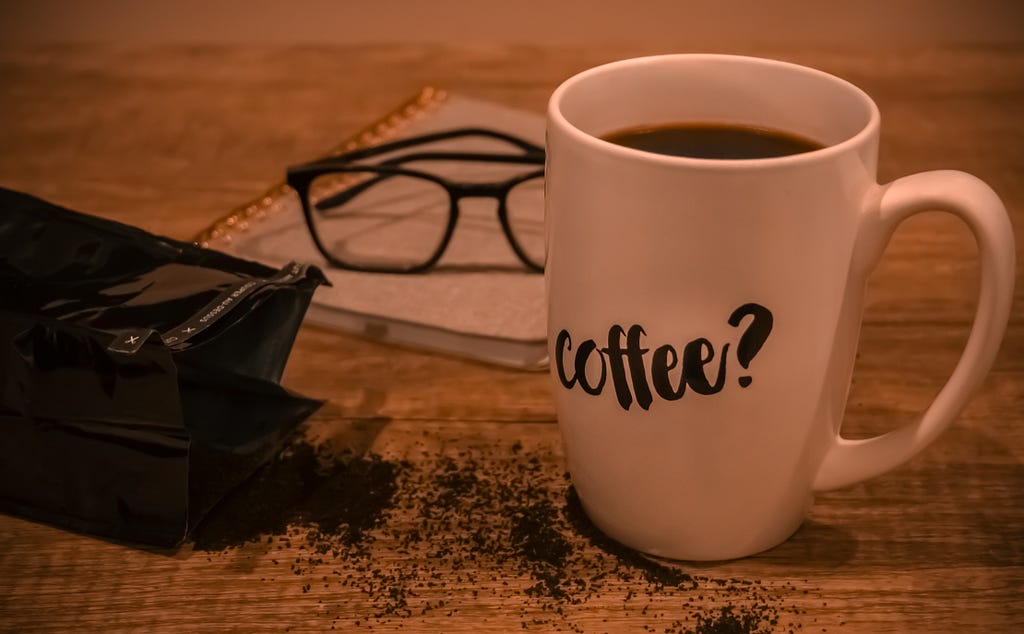 glasses next to a cup of coffee