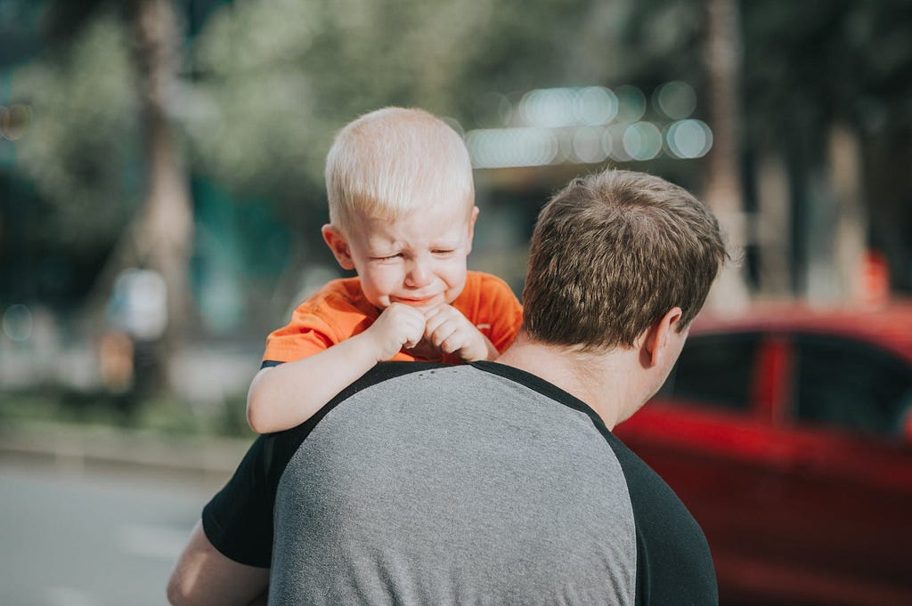 man carrying child