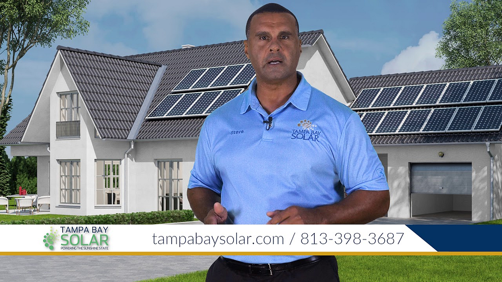 Owner of Tampa Bay Solar against a white house with solar panels