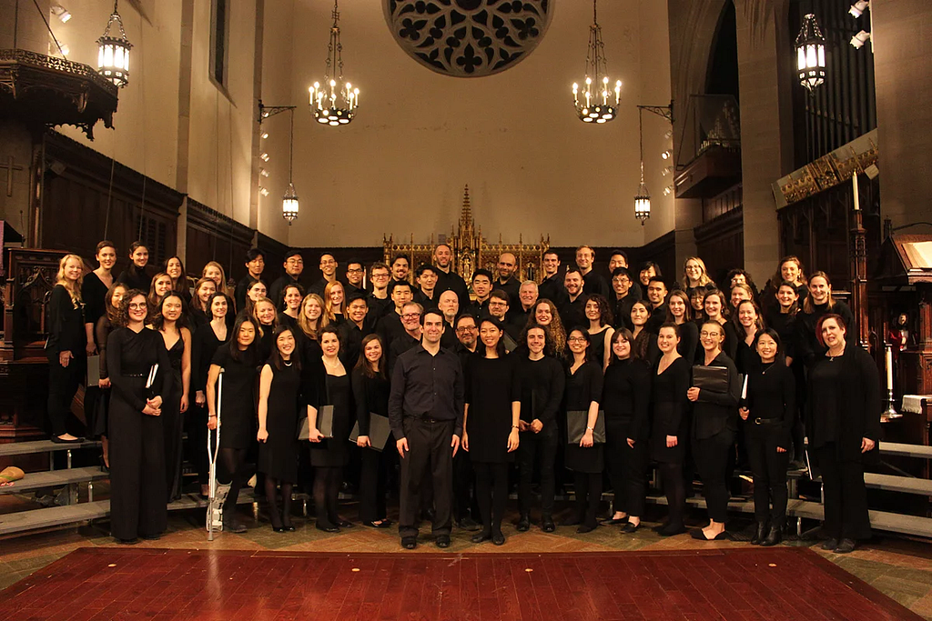The Longwood Chorus poses in a concert setting.