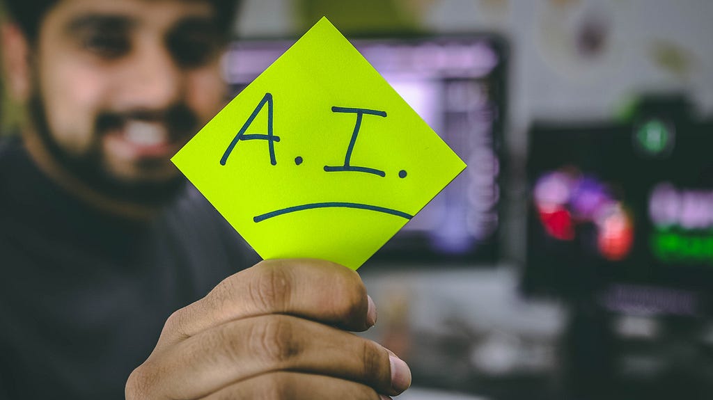 A man showing an A.I sticky note