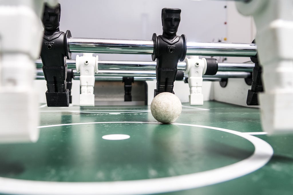 table football with ball on a player, ready to kick off