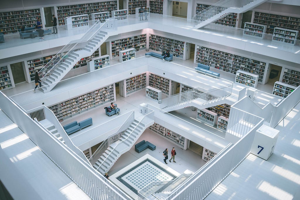 Looking into the atrium of a bright, modern library filled with shelves of books.