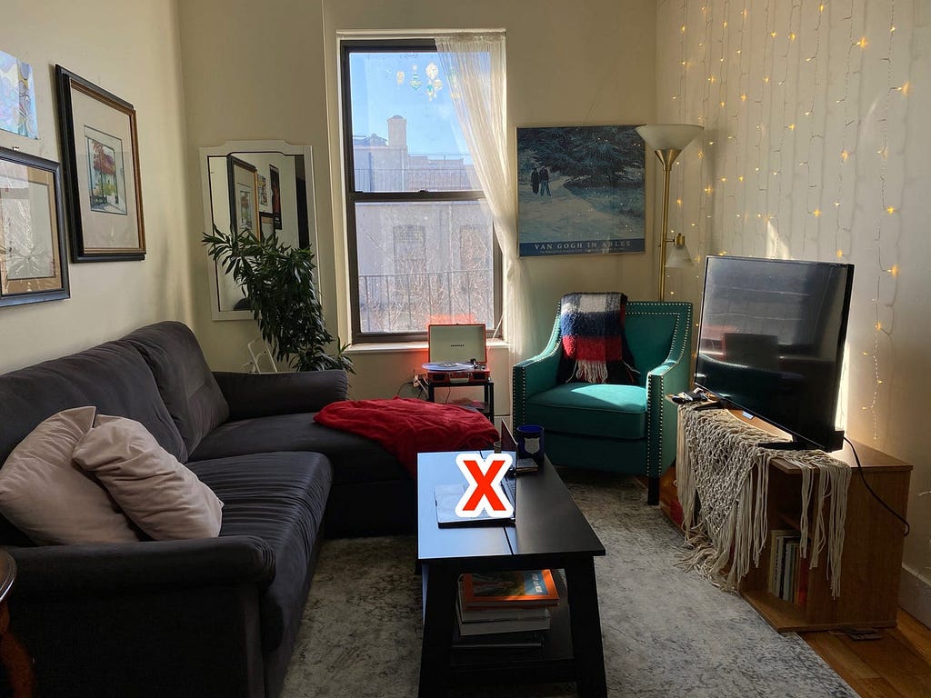 A living room with an X over the coffee table.