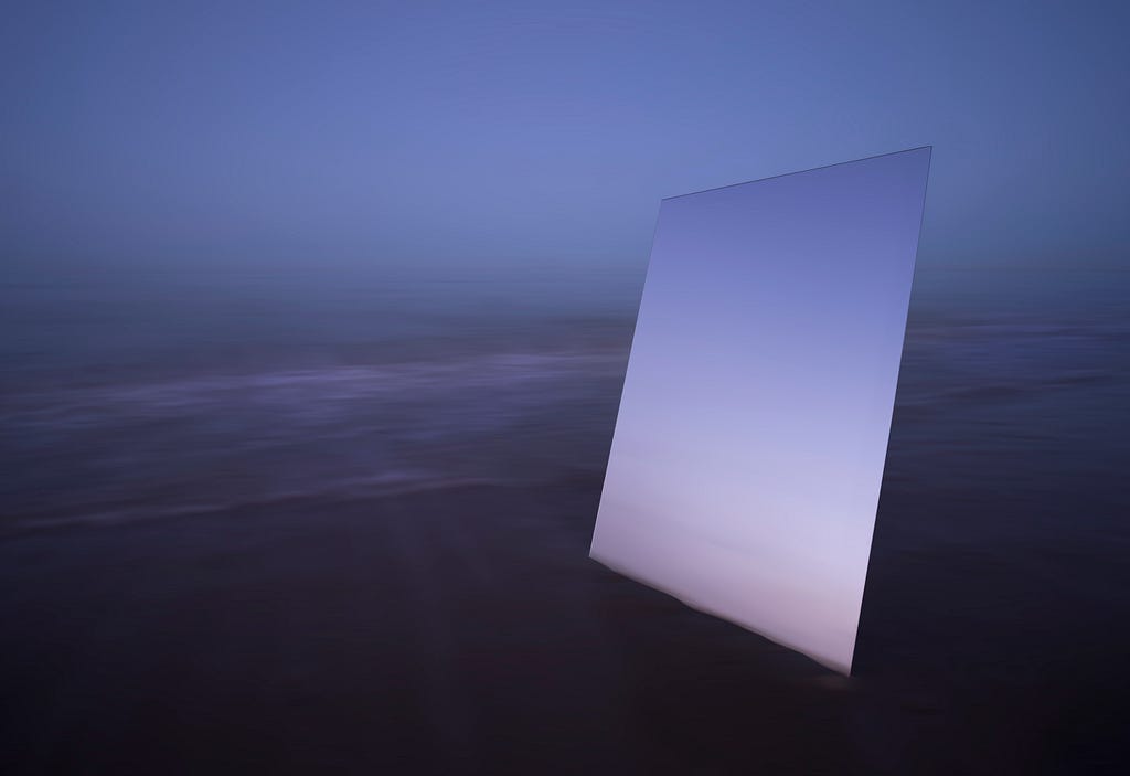Mirror reflecting sky on a foggy beach