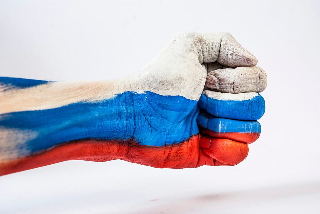 Horizontal clenched fist painted white, blue, and red stripes like the Russian flag