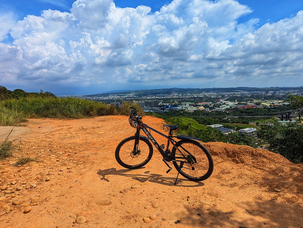 My bike on the edge of the mountain. Orange dirt.