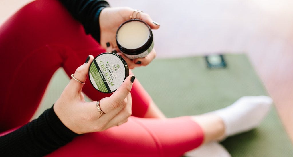 A woman using CBD balm