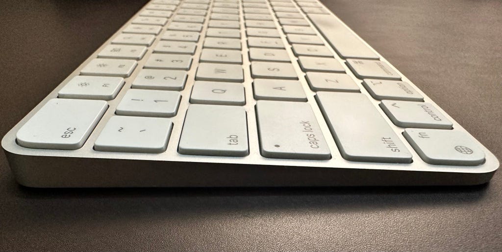 Side shot of Apple Magic Keyboard with Touch ID — showing contoured design